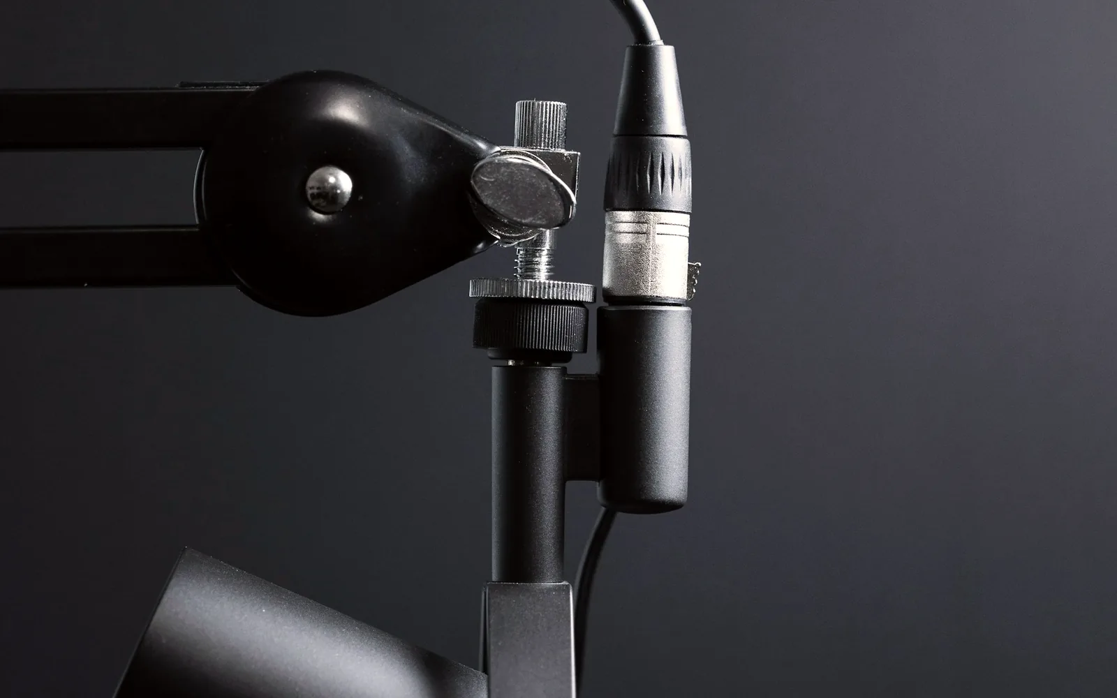 Studio microphone on a boom arm, used to check voice audio before a screen recording